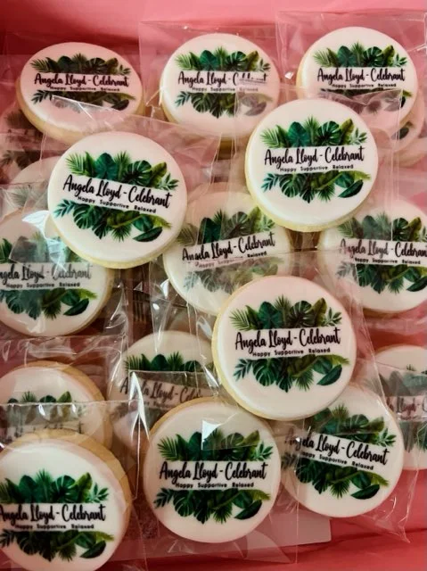Celebrant cookies decorated with Angela Lloyd branding.